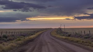 Country road under breaking storm light
